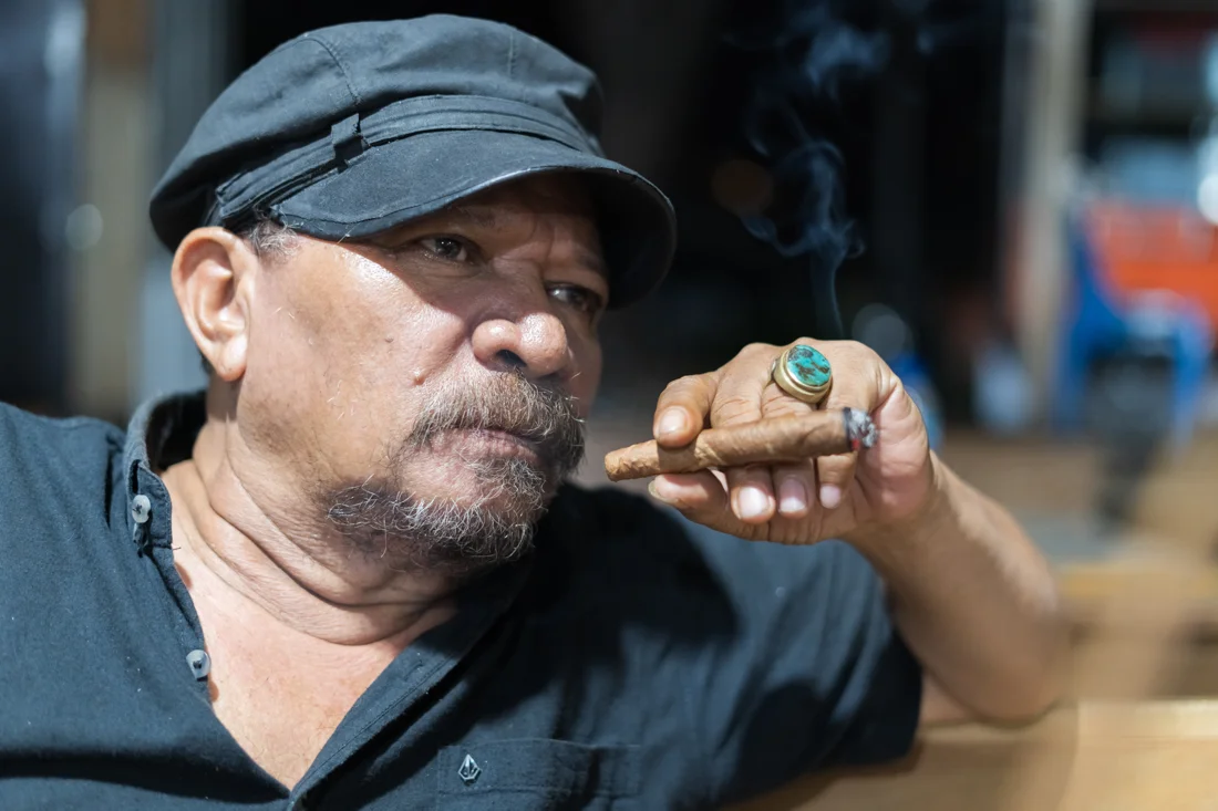 Asian man teaching Cigar Etiquette